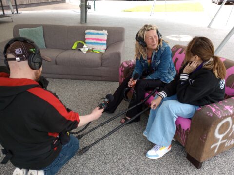 2 roving reporters interviewing someone