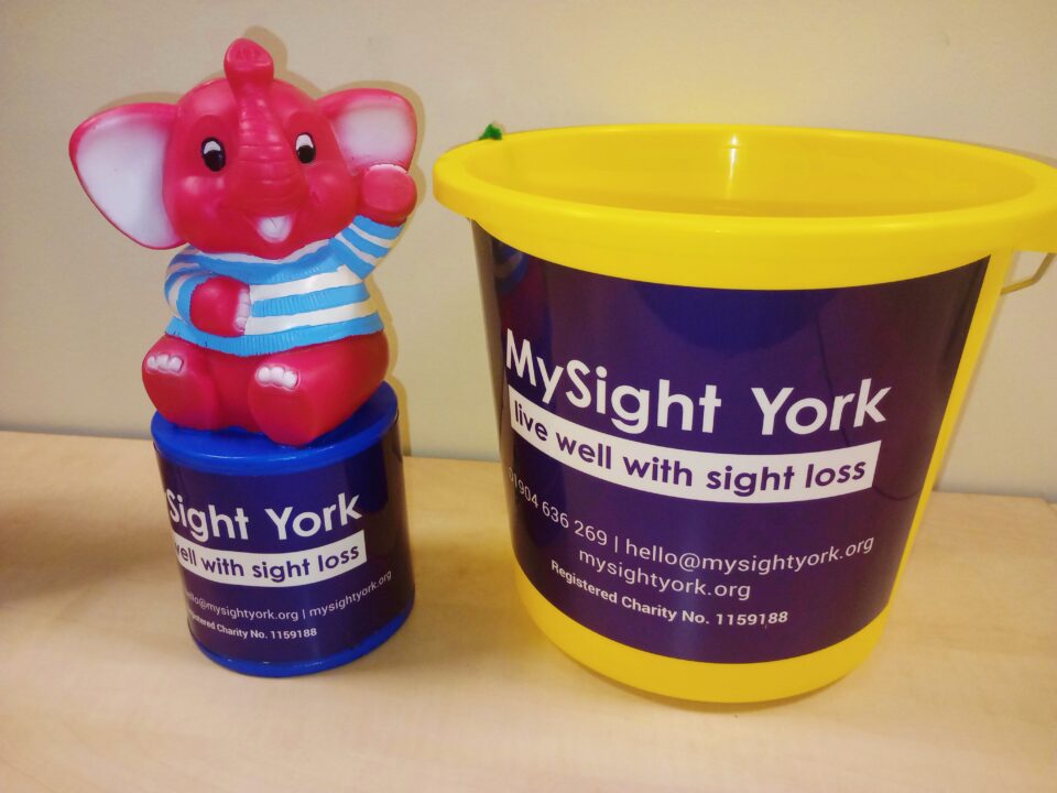 A MySight York Pink Elephant tin and a yellow MySight York collection bucket