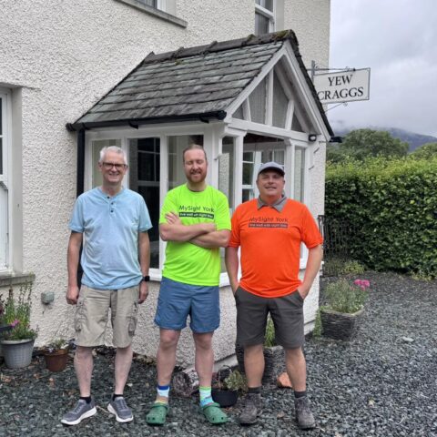 Chris and one of his support team are stood in front of Yew Craggs entrance, with Colin from Yew Craggs on the left. The man in the middle and Chris (on the right) are wearing brightly coloured MySight York fundraising t-shirts.