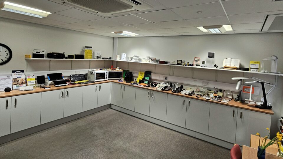 MySight York's Equipment Centre - there are cabinets with displays of the different equipment all along the top. There is also shelves with equipment on display.